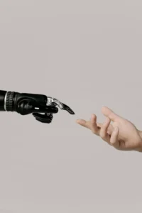 Human hand reaching toward AI robotic hand