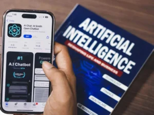 AI chatbot app on phone next to artificial intelligence book