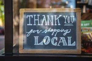 Chalkboard sign that says 'Thank you for shopping local