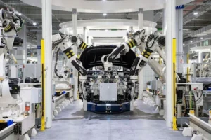 Robotic arms assembling a car in an automotive factory