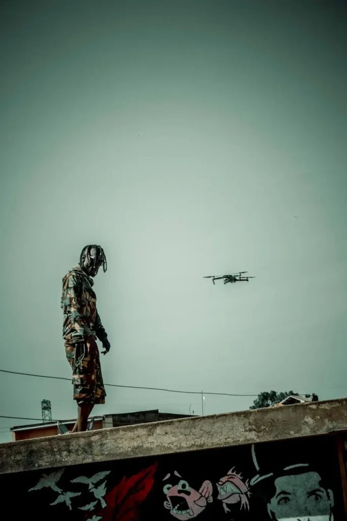 Soldier monitoring AI surveillance drone in modern warfare
