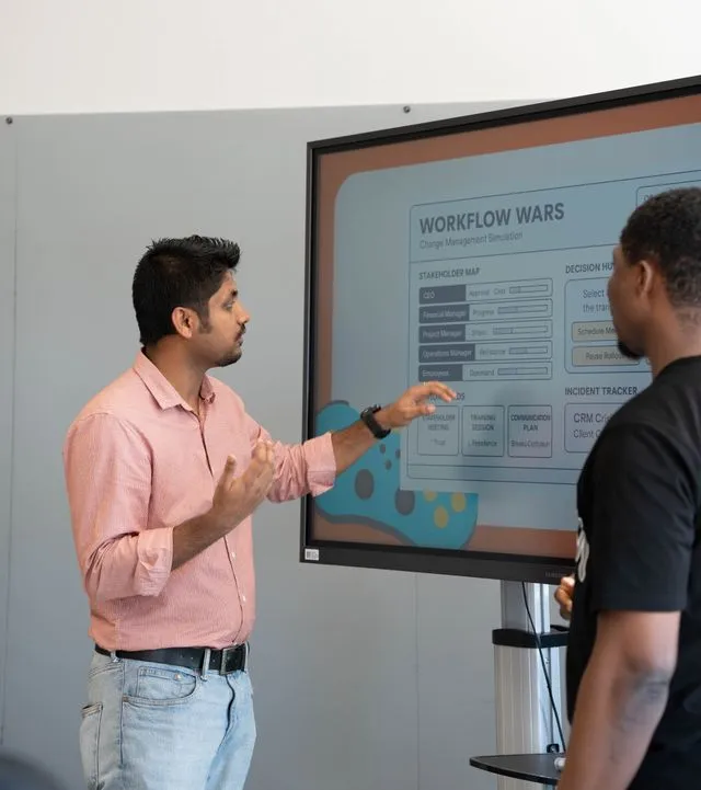 Professional explaining workflow strategy simulation on interactive digital screen
