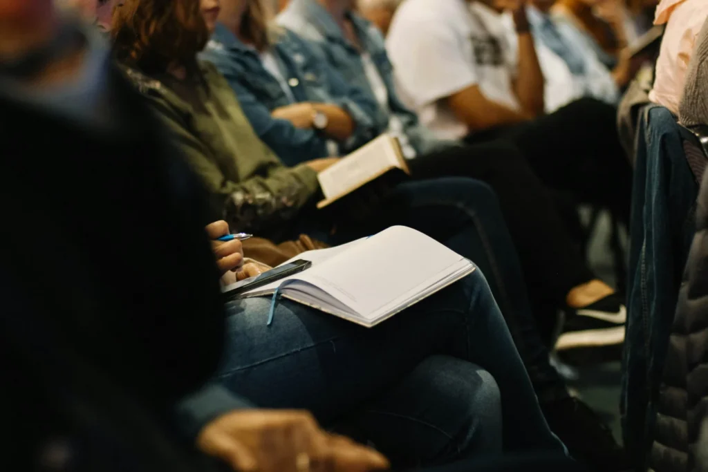 Audience members taking down notes during the employee reskilling seminar